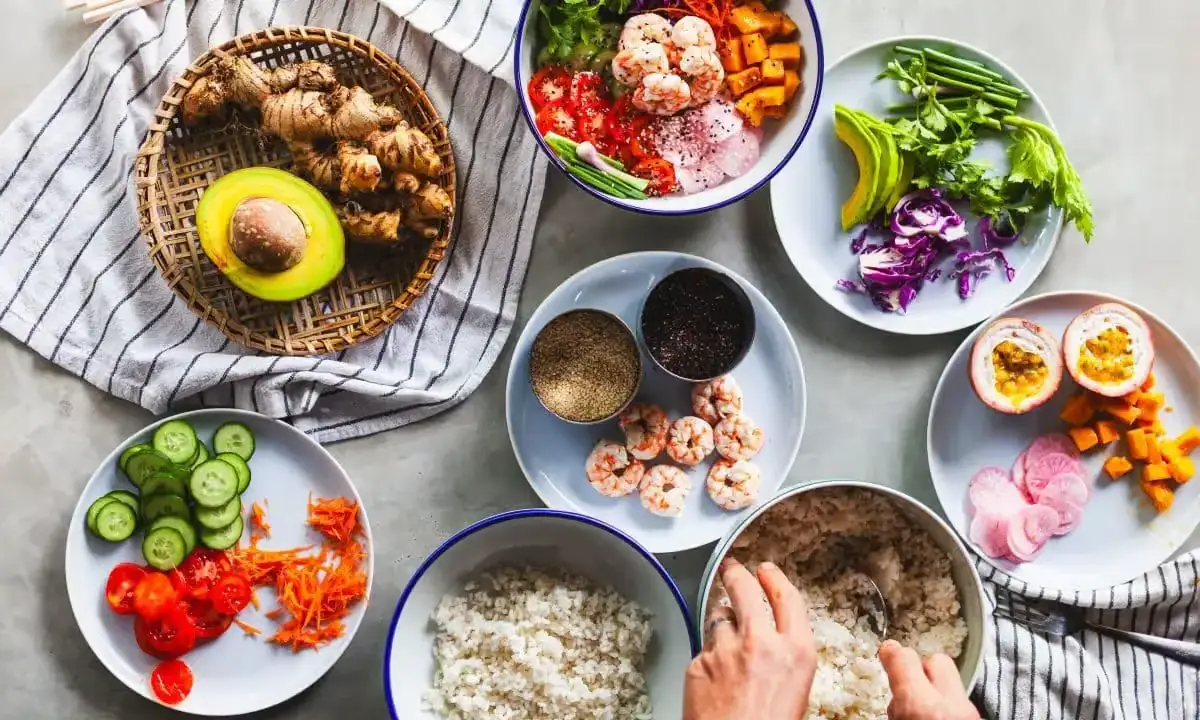 Colorful fresh poke bowls with rice, greens, avocado slices, and assorted toppings