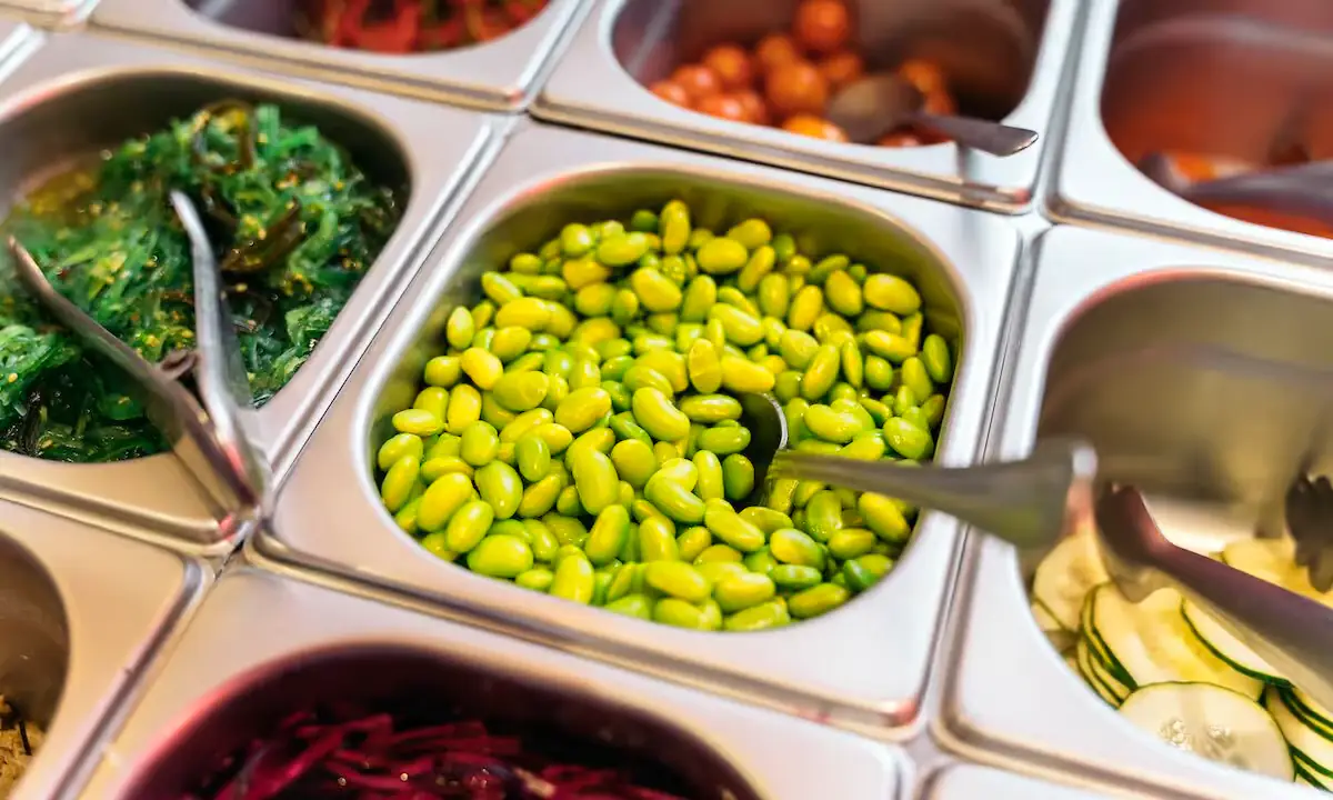 Buffet-style spread of bowls and assorted poke toppings