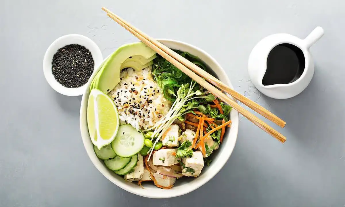 Vibrant vegetarian poke bowl with rice and assorted colorful fresh toppings