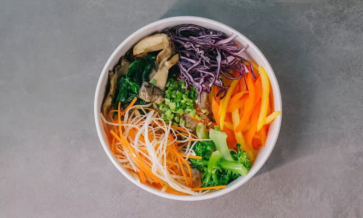 Colorful customizable poke bowl with fresh vegetables and proteins